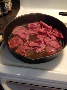 Simmering roast beef with onion soup mix.